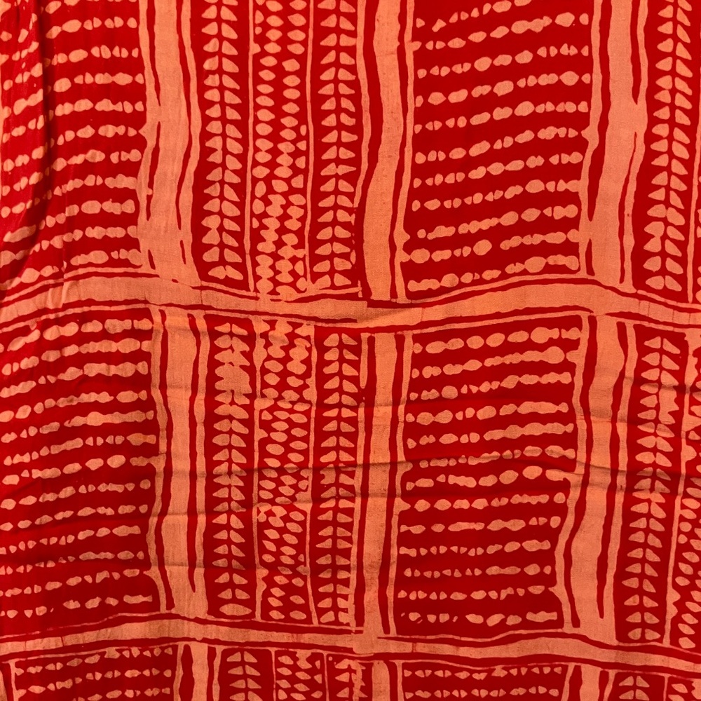 Patterned Pareo in red -orange and coral. NWOT.